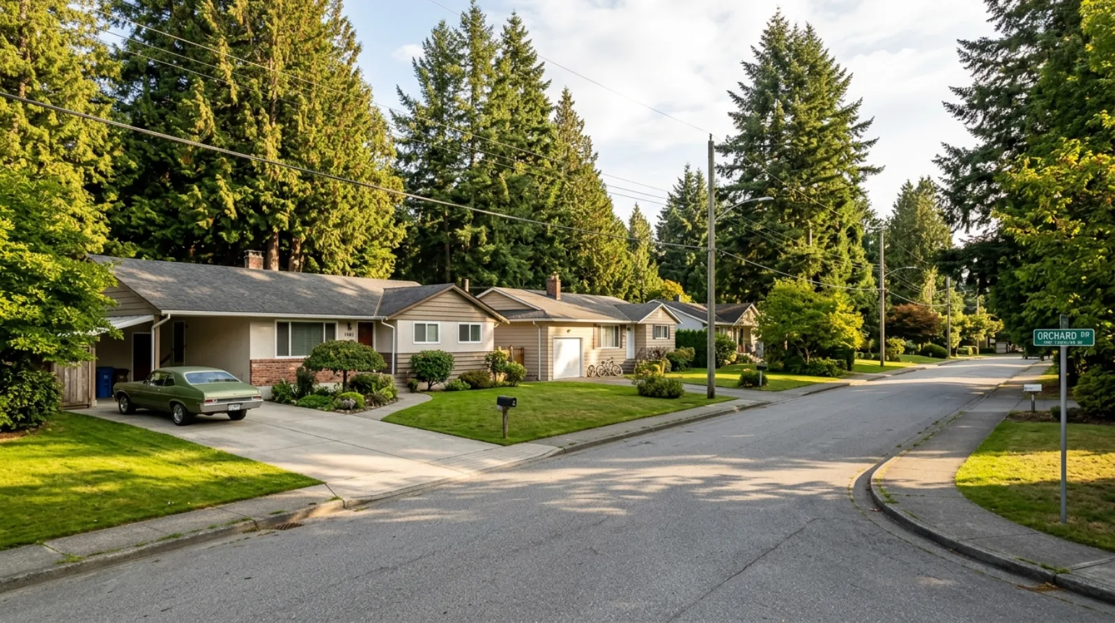 A 1960s bungalow on a quiet Glenwood street in Port Coquitlam, with a mature cedar hedge and a double-width driveway